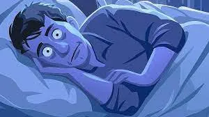 Cartoon of a wide-eyed man lying awake in bed at night under blue light