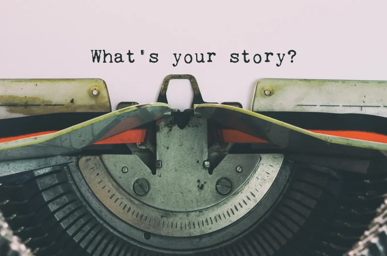 Vintage typewriter with the typed line What's your story? on white paper